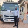 Customer with a MITSUBISHI CANTER flatbed truck exported from Japan to Zambia through EVERYCAR.jp